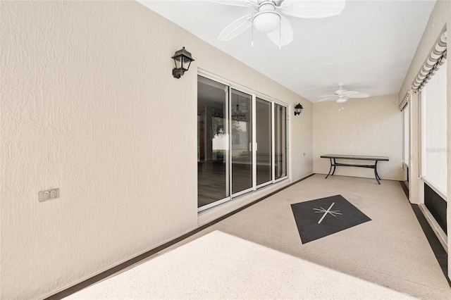 sunroom / solarium featuring ceiling fan