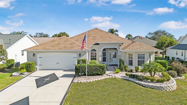 mediterranean / spanish-style home with a garage and a front lawn