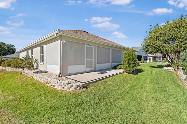 back of house with a sunroom and a yard