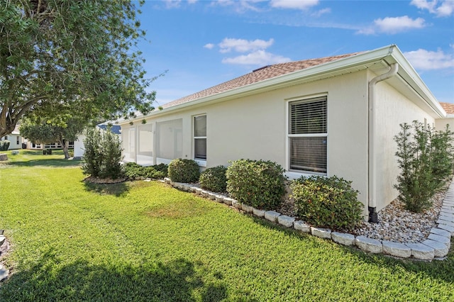 view of side of home featuring a lawn