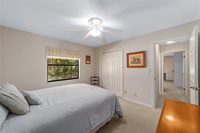 carpeted bedroom featuring ceiling fan and a closet