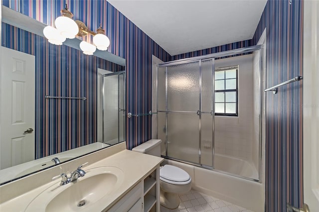 full bathroom with tile patterned flooring, vanity, toilet, and enclosed tub / shower combo