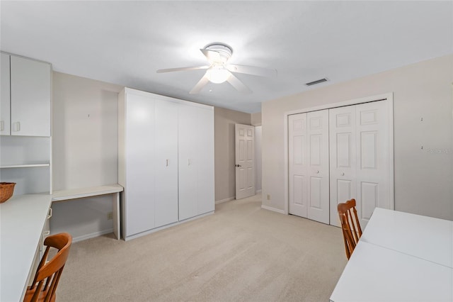 office area with light colored carpet and ceiling fan