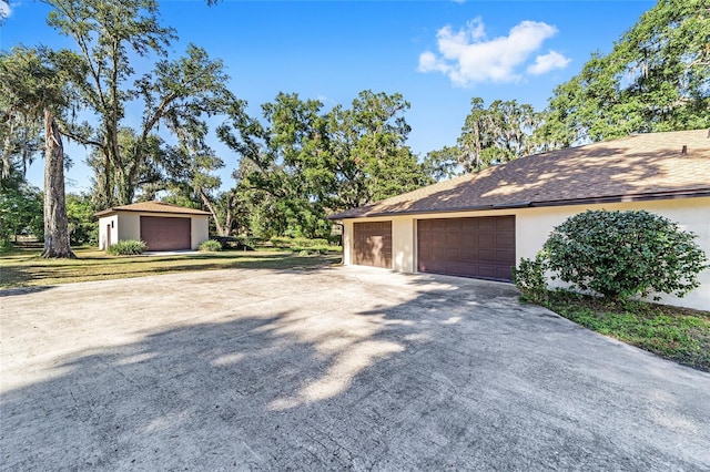 view of home's exterior featuring a garage and an outbuilding