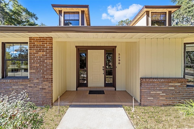 view of exterior entry with covered porch