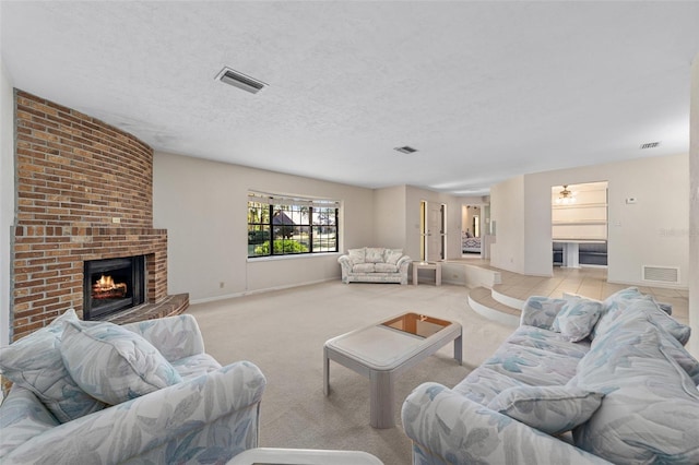 living room featuring light carpet, a textured ceiling, and a brick fireplace