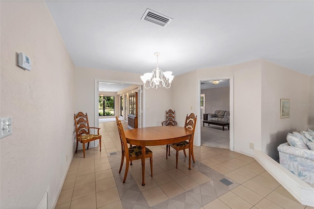 tiled dining room featuring a notable chandelier