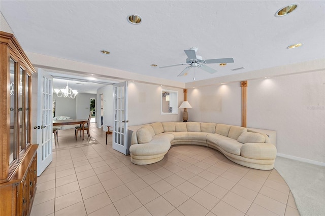 living room featuring french doors, light tile patterned floors, and ceiling fan with notable chandelier