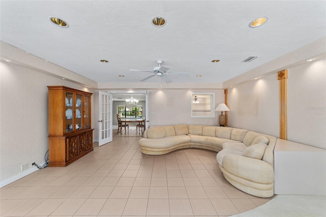 living room with ceiling fan, french doors, and light tile patterned flooring