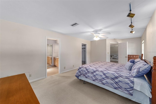 carpeted bedroom with connected bathroom, a closet, a spacious closet, and ceiling fan