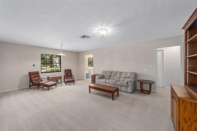 carpeted living room featuring a textured ceiling