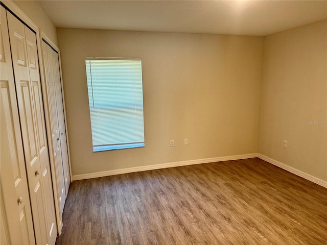 unfurnished bedroom featuring hardwood / wood-style flooring