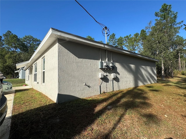 view of home's exterior with a yard