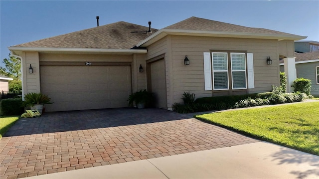 ranch-style home featuring a garage and a front yard