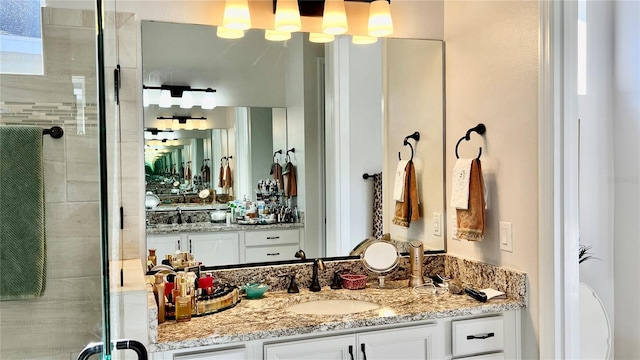 bathroom featuring vanity and an enclosed shower