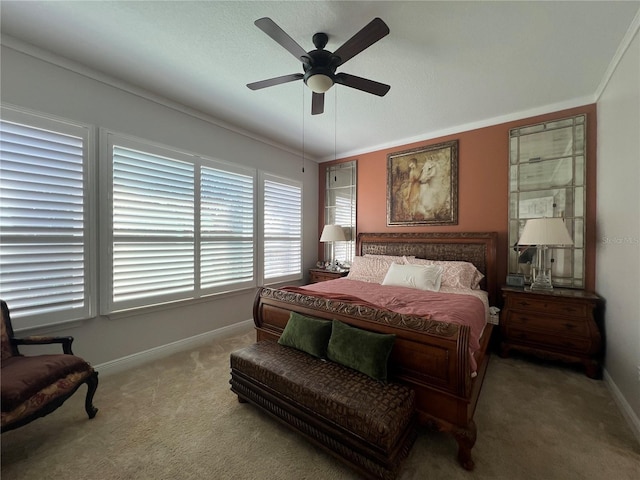 carpeted bedroom featuring ceiling fan and crown molding