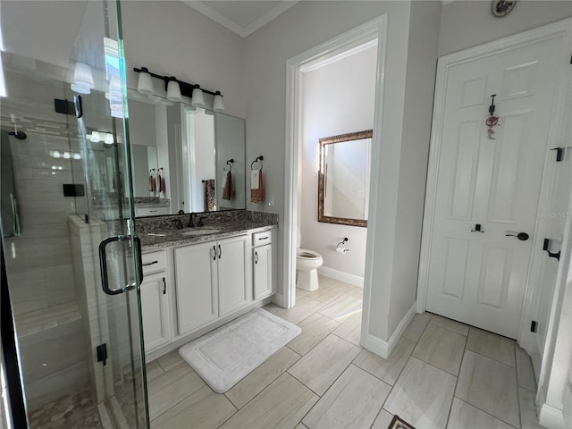 bathroom featuring vanity, ornamental molding, an enclosed shower, and toilet