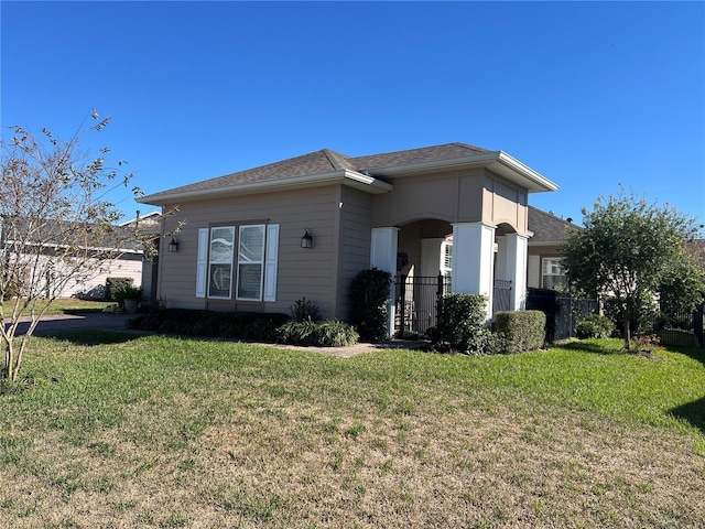 view of side of property with a lawn