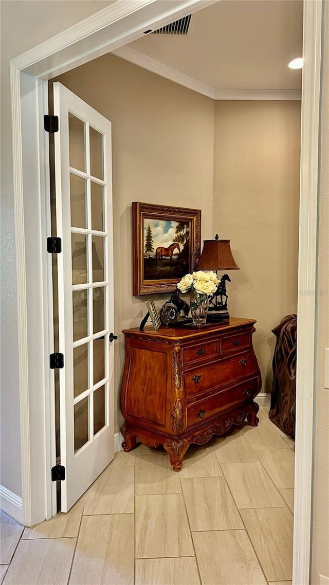 interior space with crown molding and french doors