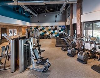 exercise room featuring a high ceiling