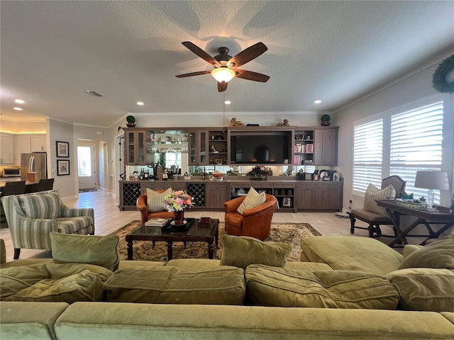 living room featuring ceiling fan, a healthy amount of sunlight, and light wood-type flooring