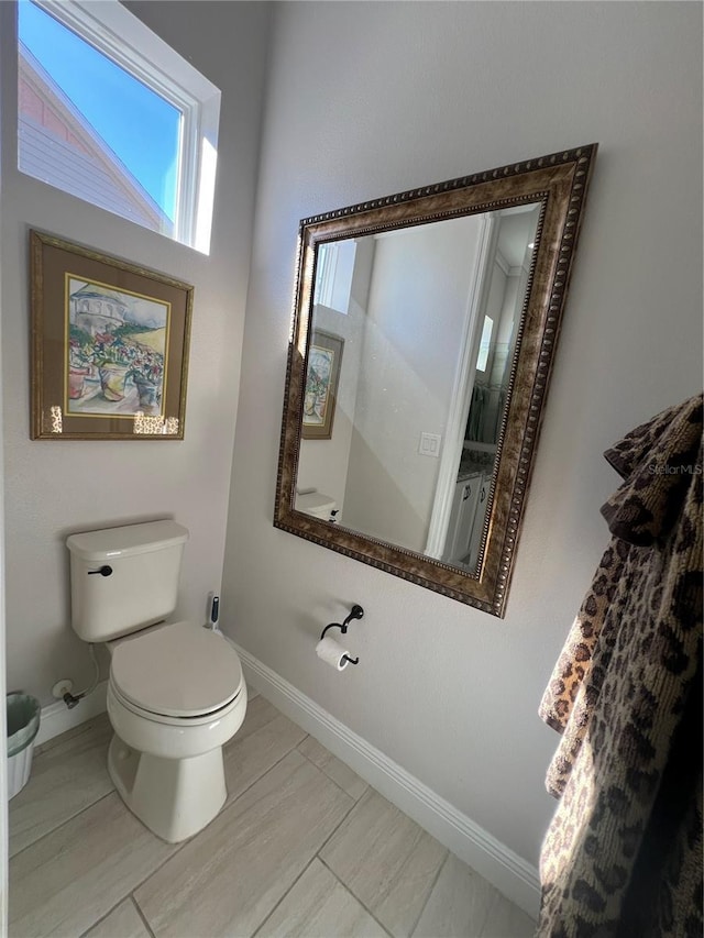 bathroom with tile patterned flooring and toilet