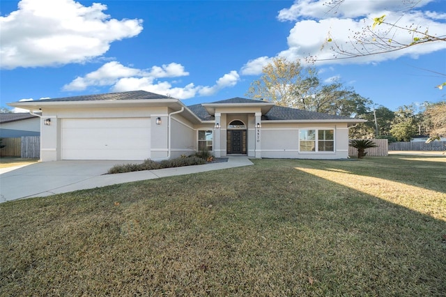 view of front of home with a garage and a front lawn