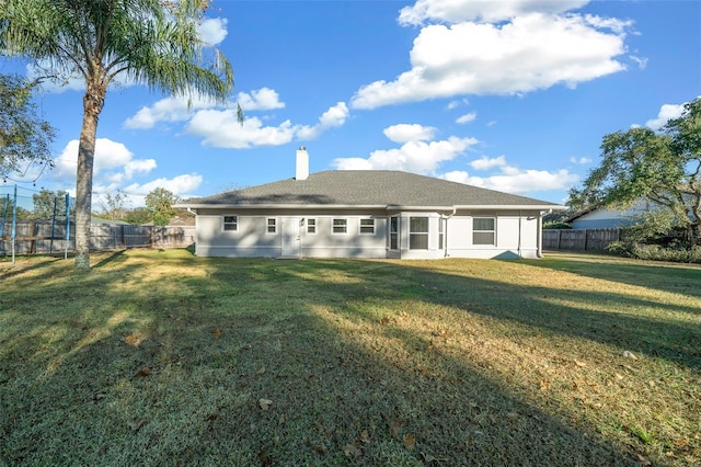 back of house featuring a lawn