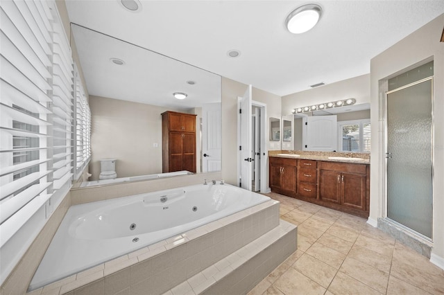 full bathroom featuring tile patterned flooring, vanity, toilet, and independent shower and bath