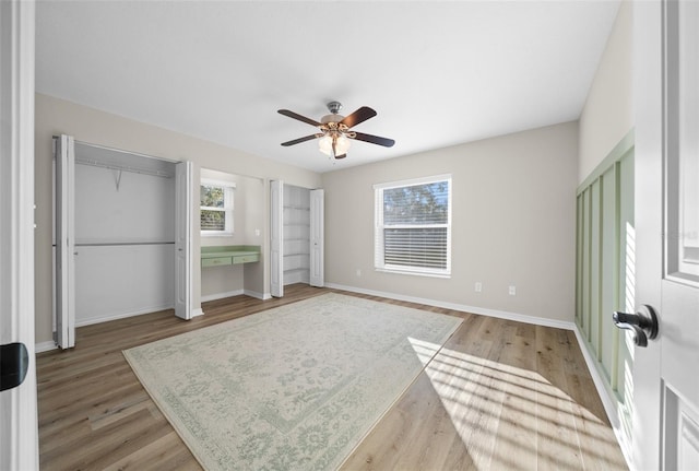 bedroom with hardwood / wood-style flooring and ceiling fan