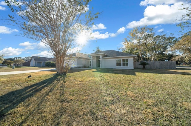 ranch-style home featuring a front yard