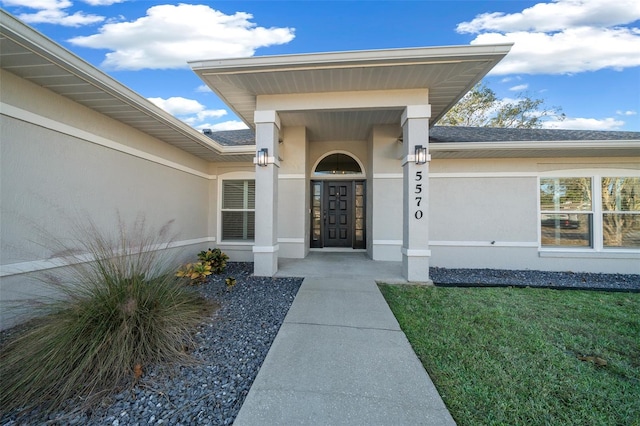 doorway to property with a yard