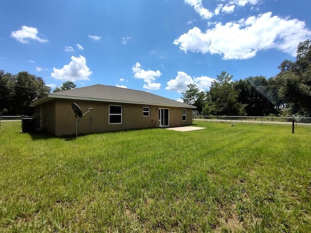 rear view of property featuring a patio area and a yard