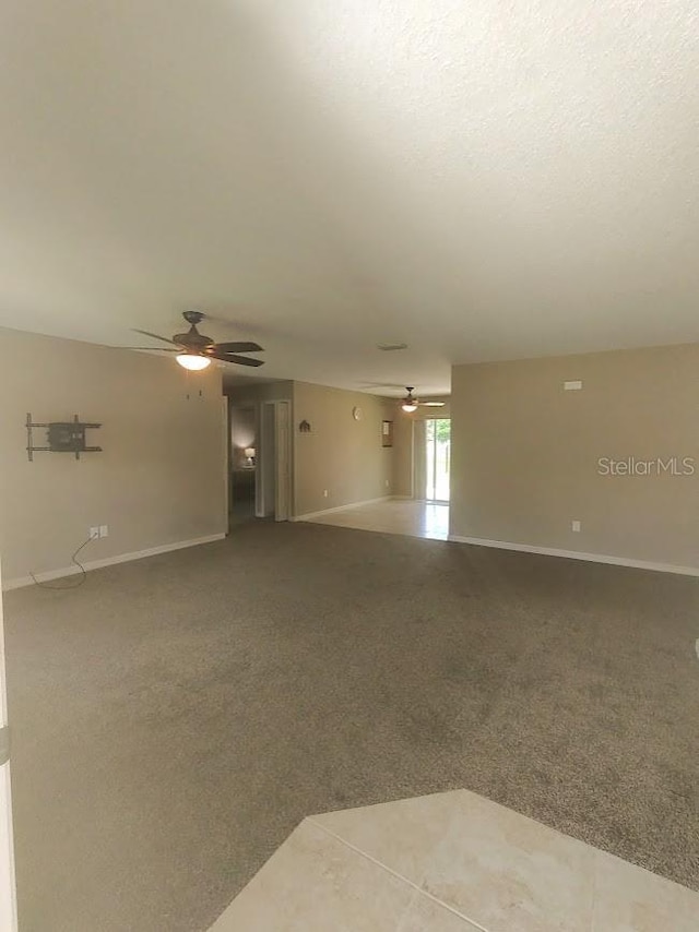 carpeted empty room featuring ceiling fan