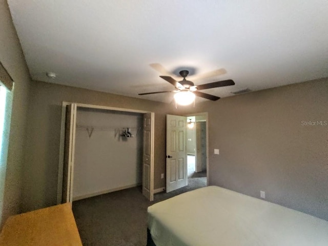 carpeted bedroom featuring a closet and ceiling fan