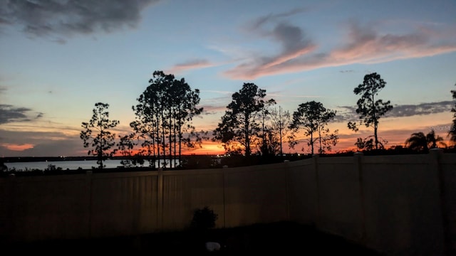 yard at dusk with a water view