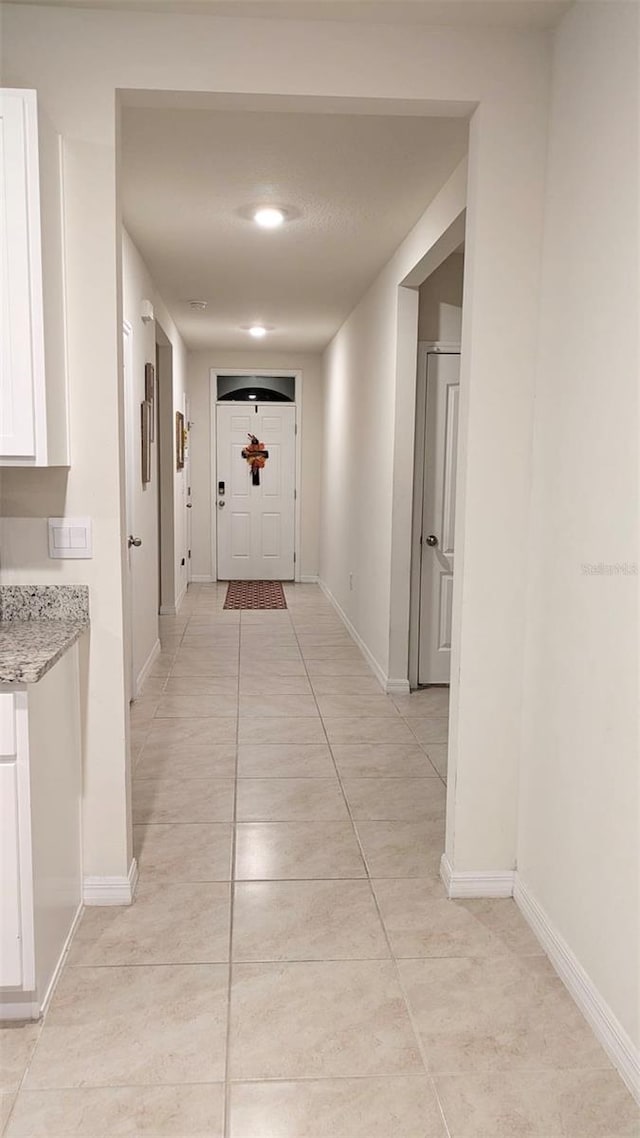 hallway with light tile patterned floors