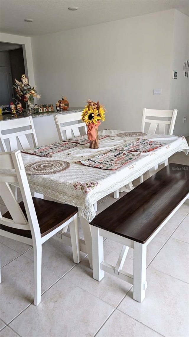 unfurnished dining area featuring light tile patterned floors