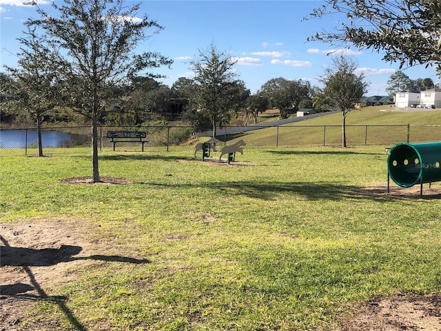 surrounding community featuring a yard and a water view