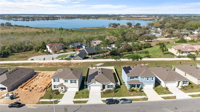 drone / aerial view with a water view and a residential view