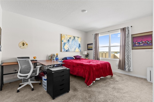 carpeted bedroom featuring a textured ceiling and baseboards