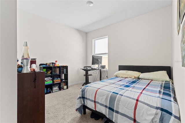 carpeted bedroom featuring baseboards