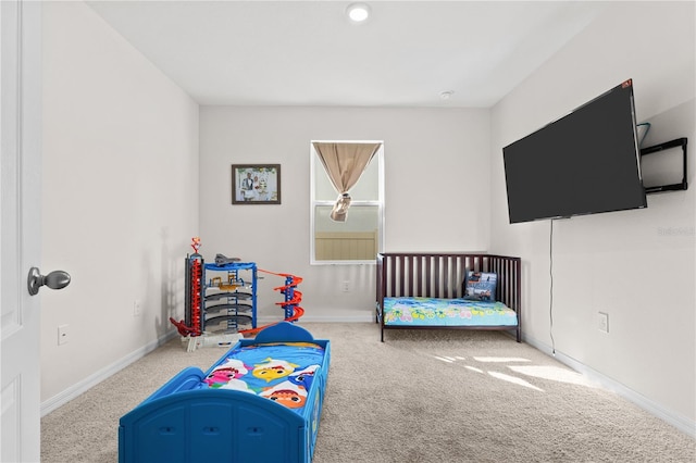 carpeted bedroom with baseboards