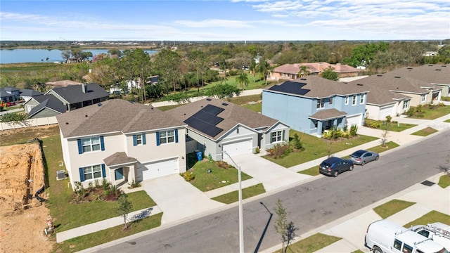 birds eye view of property featuring a water view and a residential view