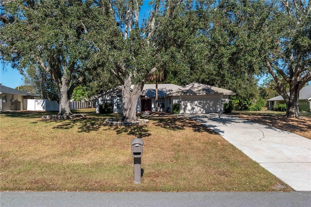 view of front of home featuring a front lawn and a garage