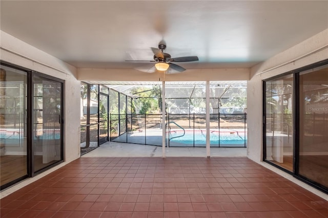 unfurnished sunroom with ceiling fan