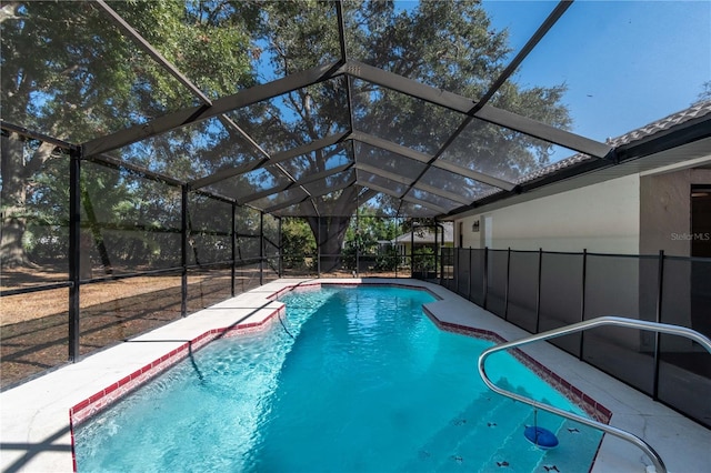 view of pool with glass enclosure and a patio area