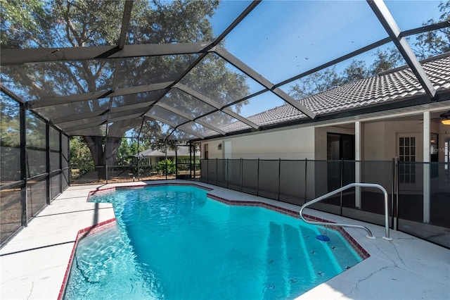 view of swimming pool with a patio and a lanai