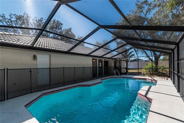 view of swimming pool with a patio and glass enclosure