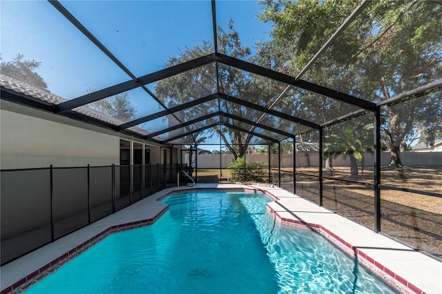 view of pool with glass enclosure